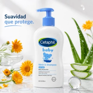 Botella blanca con dispensador azul de Cetaphil Baby Wash y Shampoo 2 en 1, con de elefante, rodeada de flores de caléndula y hojas de aloe vera sobre superficie brillante.